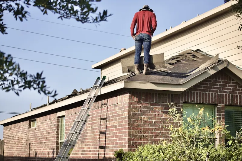 Professional roofer working on a residential roof in North Riverdale